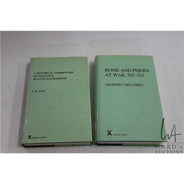 Two hardcover books including "Rome and Persia, 502-532" by Geoffrey Greatrex and "A Historical Comm