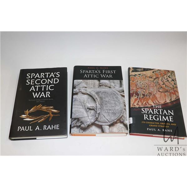 Three hardcover books including "Sparta's First Attic War", "The Spartan Regime" and Sparta's Second