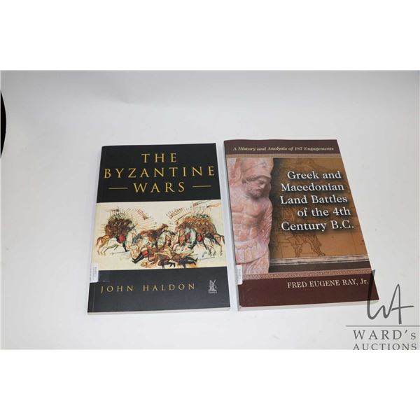 Two softcover books including "The Byzantine Wars" by John Haldon and "Greek and Macedonian Land Bat