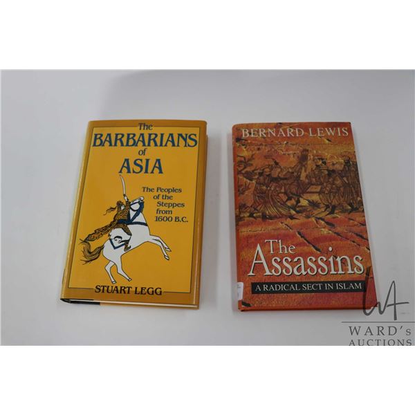 Two hardcover books including "The Assassins: A Radical Sect in Islam" by Bernard Lewis and "The Bar