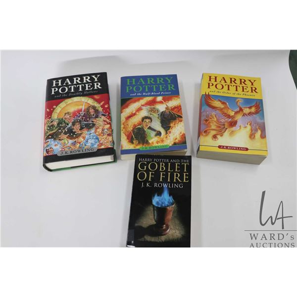 Four books from the Harry Potter series by J.K. Rowling including hardcover "Harry Potter and the De