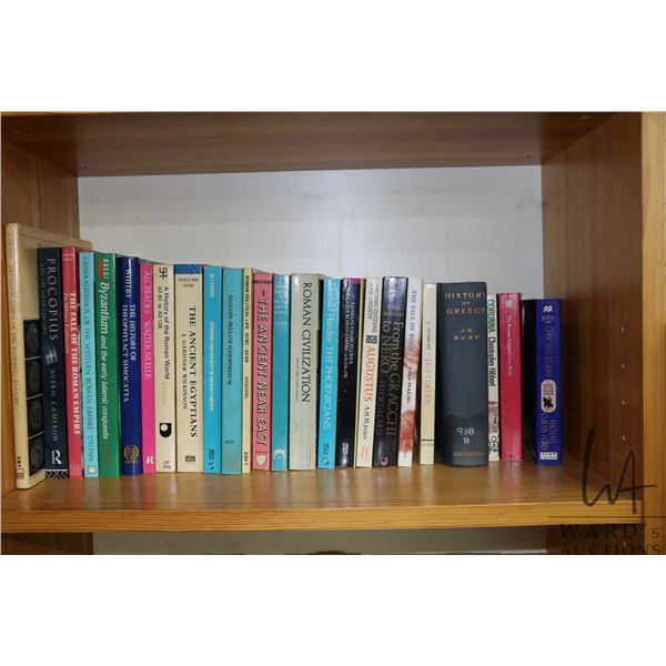 Shelf lot of paperback books including Roman and Egyptian history books etc.