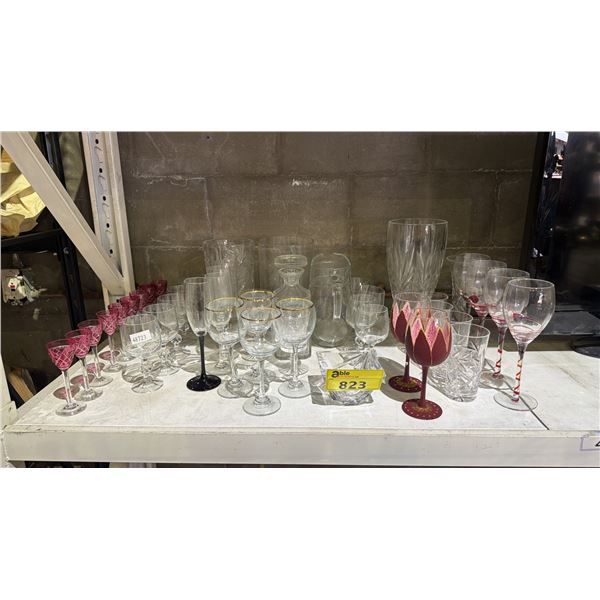 ASSORTED GLASSWARE INCLUDING; VASES, DECANTER, CHAMPAGNE GLASSES, WINE GLASSES & MORE
