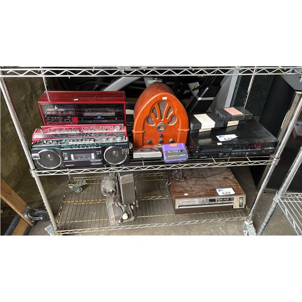 SHELF OF VINTAGE PORTABLE STEREOS, WALKMANS, SONY VCR PLAYER & VCR TAPES