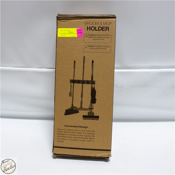 NEW IN BOX BROOM AND MOP HOLDER.