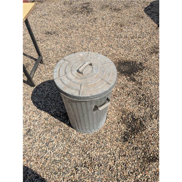 metal garbage can with garden hoses and sprinklers