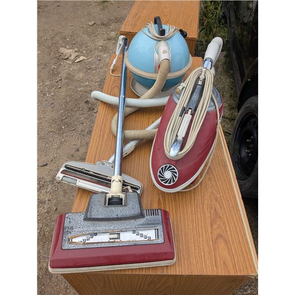 2 vintage vacuum cleaners with attach,ments