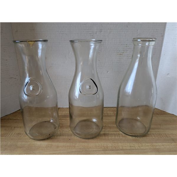 2 vintage glass juice bottles and a milk bottle