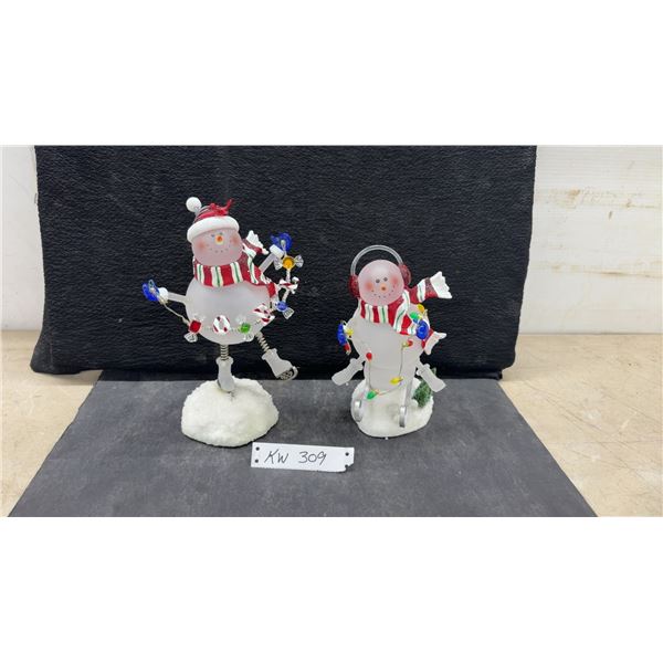 Two Frosted Glass Bobble Snowman Figurines: One Ice Skating, One Skiing, Each with Scarf & Lights.