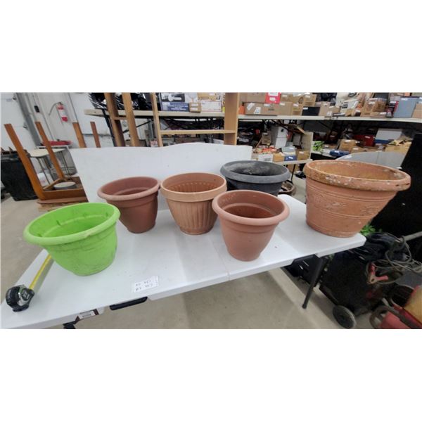 Assorted Plant Pots Including Terracotta, Green, and Gray Plastic and Clay Planters