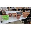Image 1 : Assorted Plant Pots Including Terracotta, Green, and Gray Plastic and Clay Planters