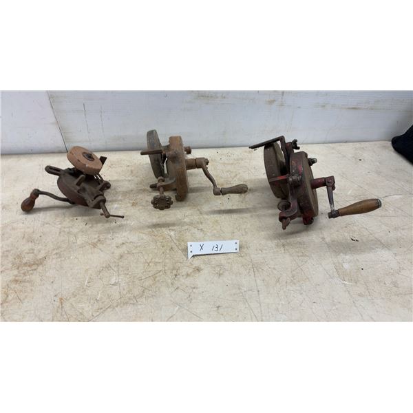 Three Hand-Crank Grinders, Including Red-Painted Grinder and Two Rust-Patina Grinders