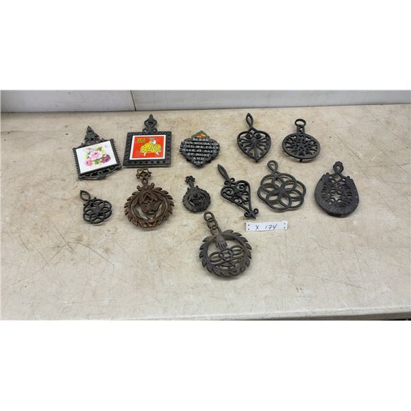 Assorted Cast Iron Trivets and Wall Hangings: "Bless This House" Plaque, Floral and Clown Tiles