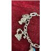 Image 15 : Avon Jewelry Lot: 2 Rings, 1 Charm Bracelet, and Tree Ornament