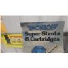 Image 6 : Monroe Super Struts, Cartridges “Sold Here,” and “Ride Safe” Advertising Signs