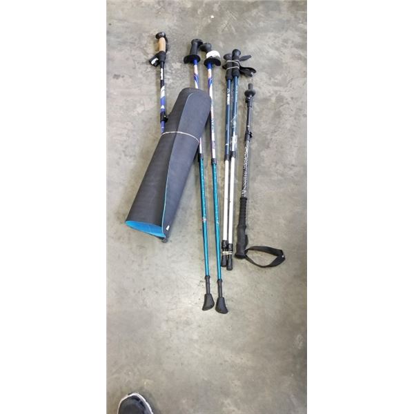2 PAIRS OF SKIING POLES AND A BLUE MAT