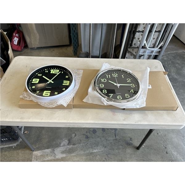 3 NEW 12 INCH WALL CLOCKS. TWO ARE BLACK WITH A CHROME FINISH. ONE IS BLACK WITH A WHITE FINISH
