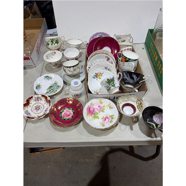 Assortment of tea, cups, and saucers