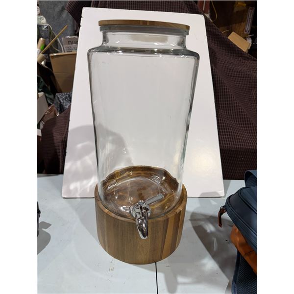 Glass juice container on stand
