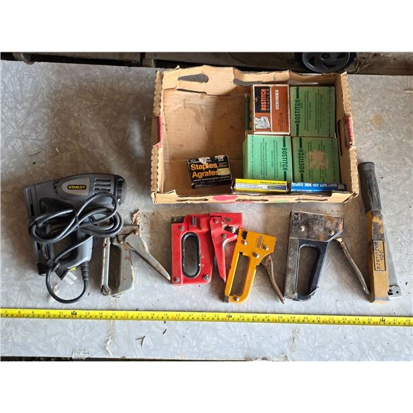 Various staple guns and boxes of staples