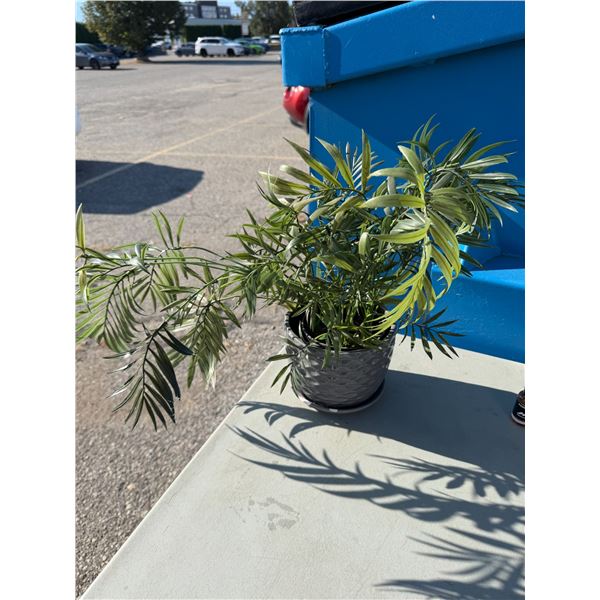Artificial plant pot has a chip
