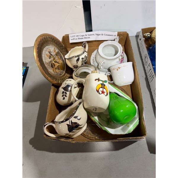 A lot of cups and saucers, sugars and creamers, as well as home decor