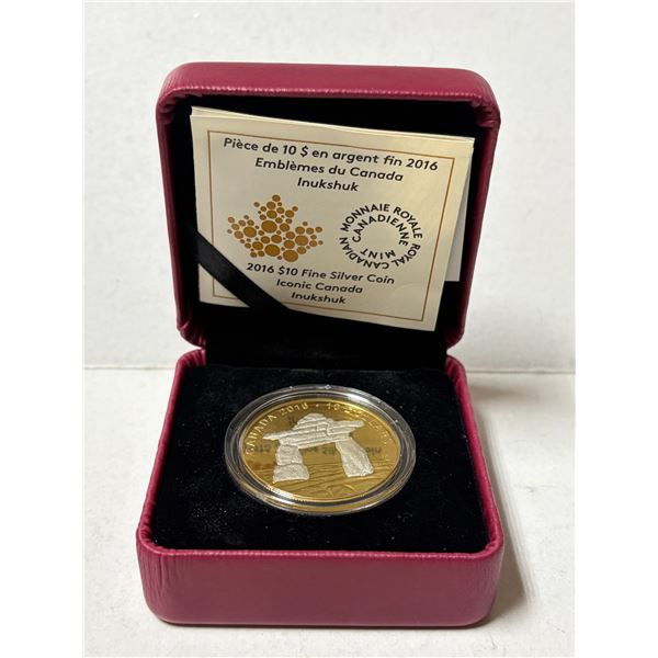 2016 $10 Iconic Canada: Inukshuk fine silver coin features a distinct reverse gold-plated background