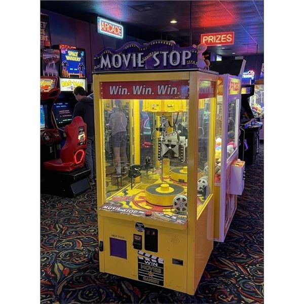 Bay Tek Movie Stop Arcade Vending Machine with a box of NEW DVD videos