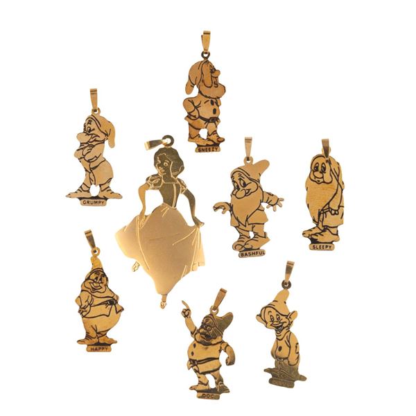 A "Snow White" Gold Charm Set.