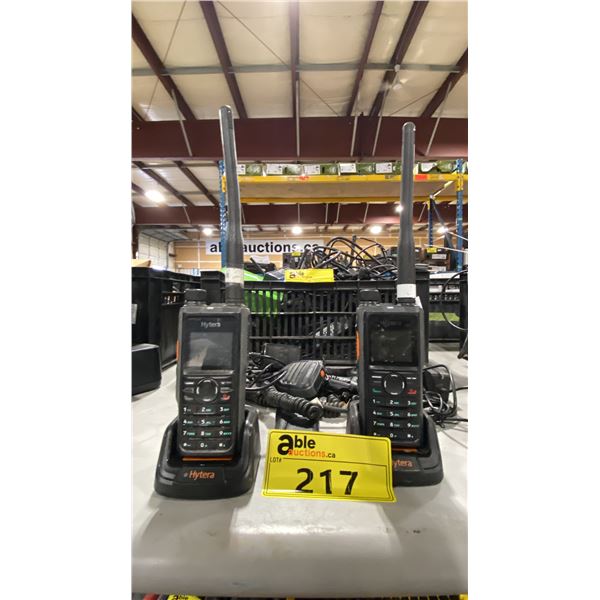 2 HYTERA HANDHELD RADIOS WITH REMOTE SPEAKERS, BASE CHARGERS, ADAPTERS, BELT CLIPS, & BATTERIES