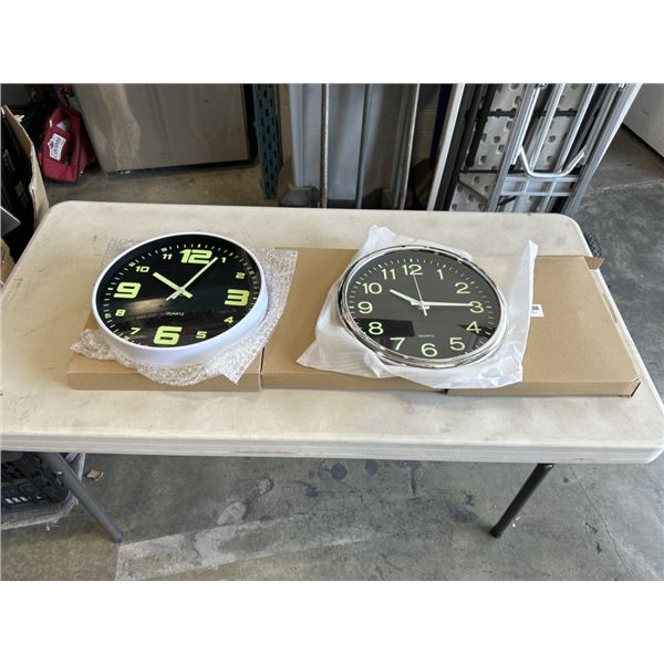 3 NEW 12 INCH WALL CLOCKS. TWO ARE BLACK WITH A CHROME FINISH. ONE IS BLACK WITH A WHITE FINISH