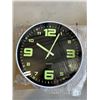 Image 2 : 3 NEW 12 INCH WALL CLOCKS. TWO ARE BLACK WITH A CHROME FINISH. ONE IS BLACK WITH A WHITE FINISH