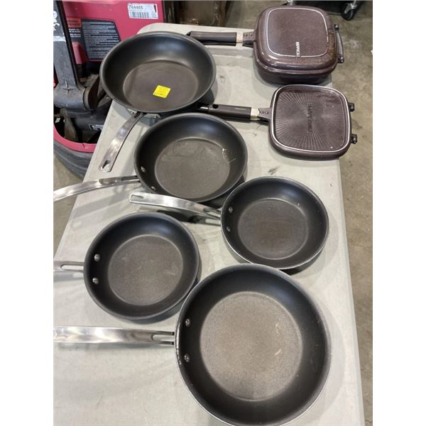 BOX OF KIRKLAND FRYING PANS AND TWO HAPPY CAT EASY FLIP FRYERS