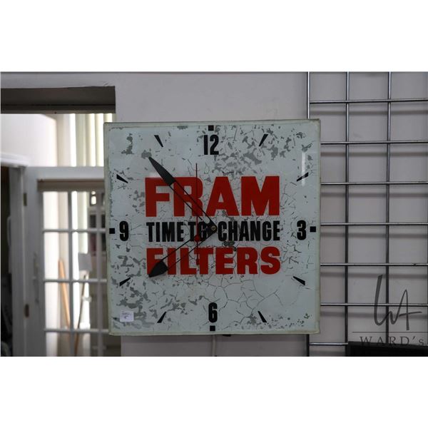 Vintage "Fram Filters" metal electric wall clock with glass face, partially lights up, working at ti