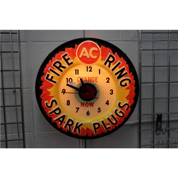 Vintage molded plastic electric AC Fire Ring Spark Plugs illuminating wall clock, working at time of