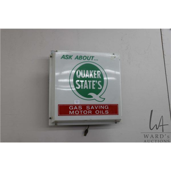 Molded plastic Quaker State Motor Oil illuminating electric advertising sign, working at time of cat