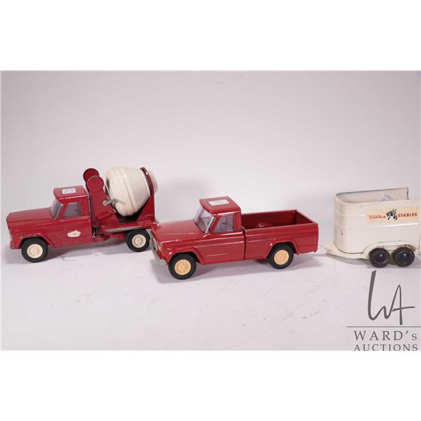 Selection of vintage Tonka toys including cement truck, pick-up truck and horse trailer