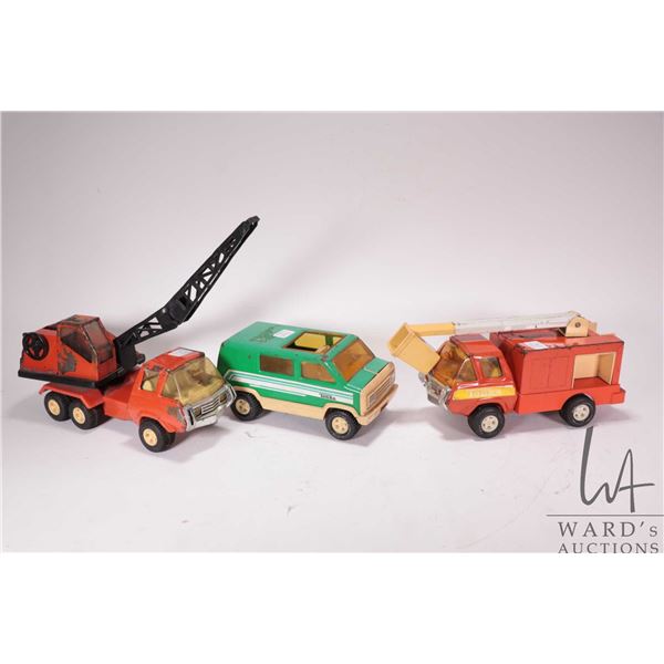 Three vintage Tonka trucks including cherry picker, a crane and a custom van