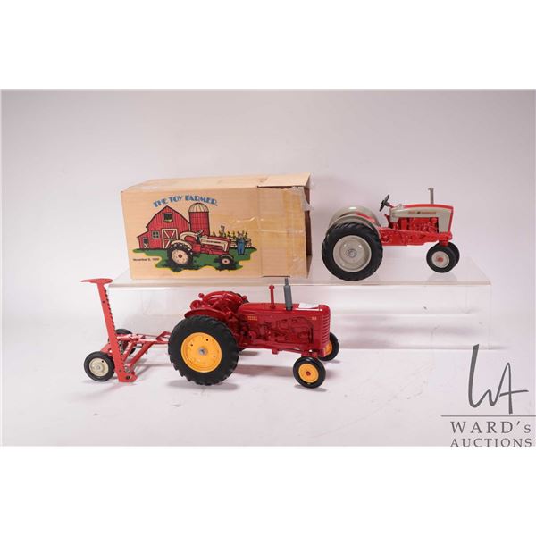 Two Ertl die cast tractors including No. 55 Massey- Harris and Ford 961 farm tractor with mower from