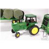 Image 3 : Three Ertl 1:18 scale die cast John Deere toys including 4450 tractor, 568 round bailer with hay bal
