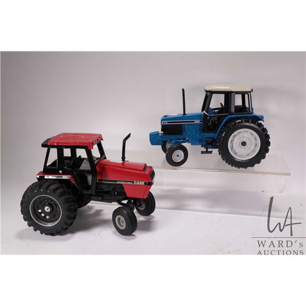 Two Ertl 1:18 scale die cast tractors including a Case 2594 and a Ford 7740
