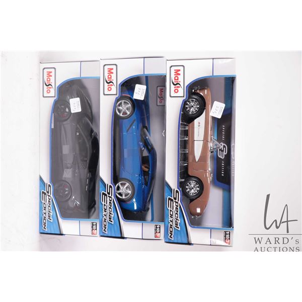 Three Maisto die cast model cars including a 1957 Chevrolet Corvette, a 2014 Corvette Stingray and a
