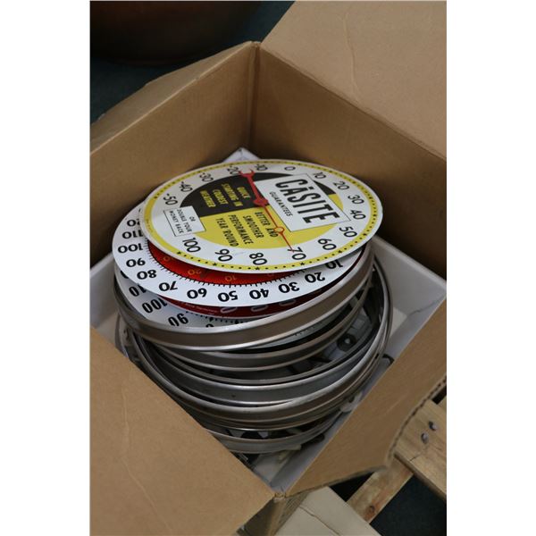 Box containing an assortment of parts and accesories for vintage wall mount thermometers