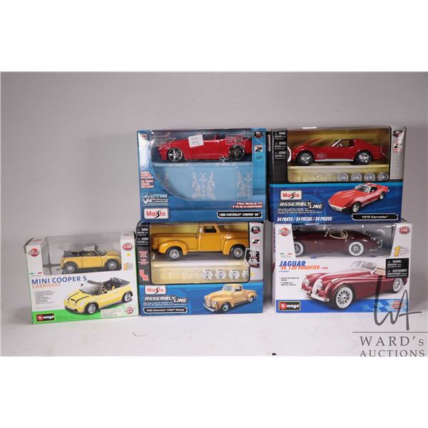 Three Maisto model kits and two Durango model car kits