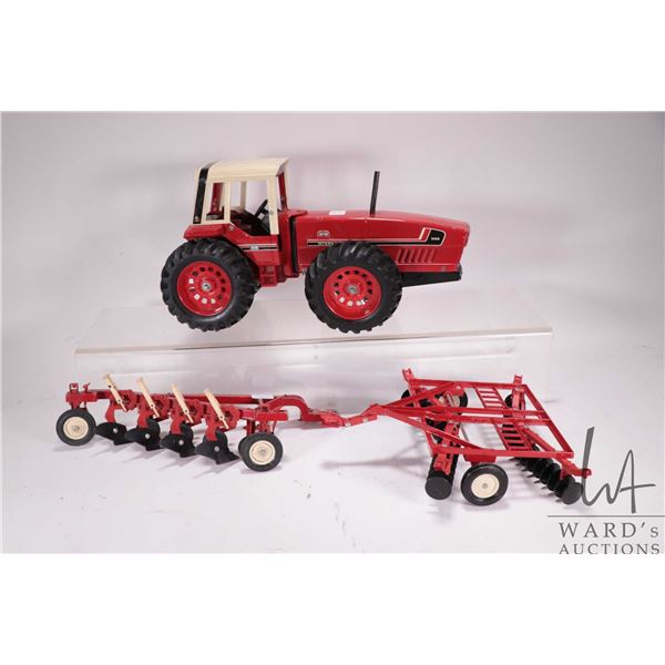 Vintage ERTL 1/16th scale die cast International 3588 2+2, a disc, and a 4 bottom plough