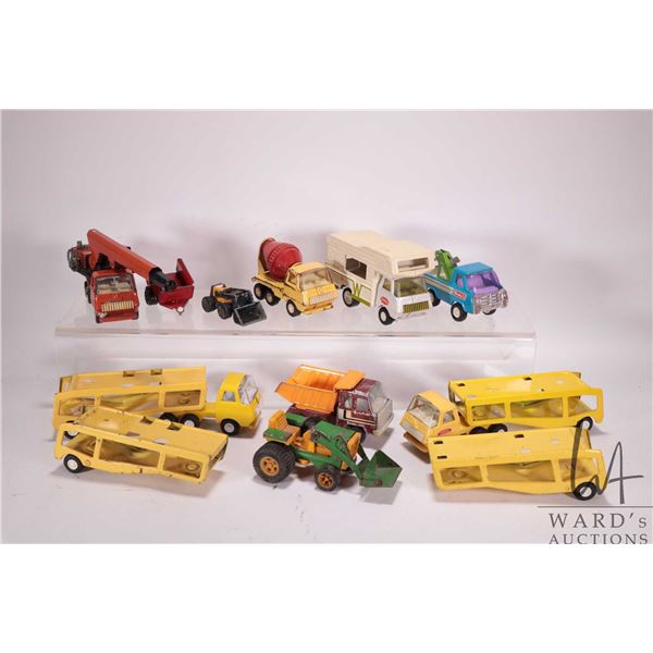 Selection of small scale tin toys including Tonka crane, 2 car carriers, cement truck, and motorhome