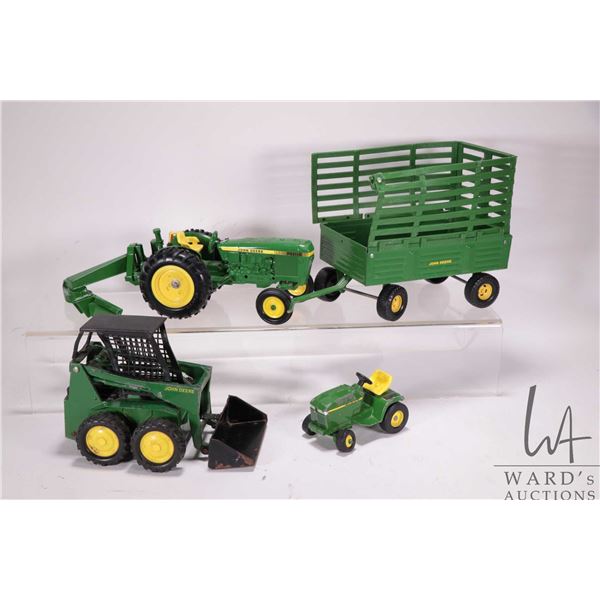 Selection of John Deere 1/18th models including ERTL tractor with blade, skid steer, wagon with exte