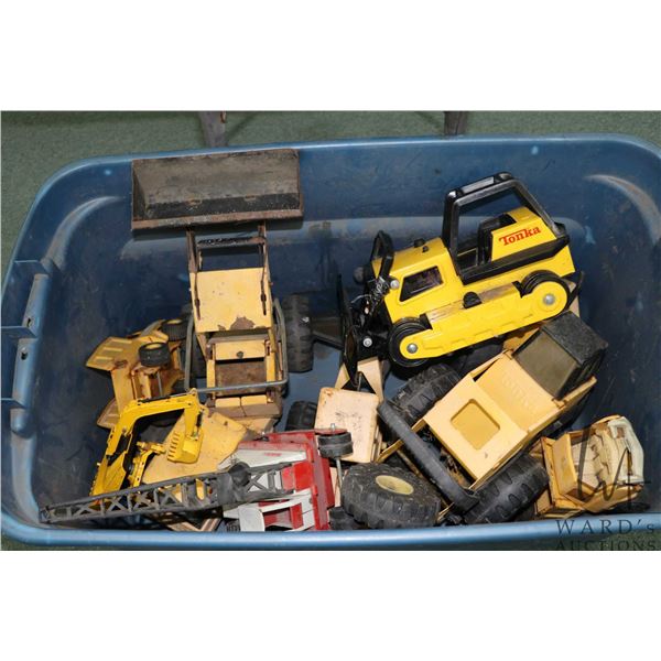Large plastic tub containing Tonka parts and toys to be used for parts