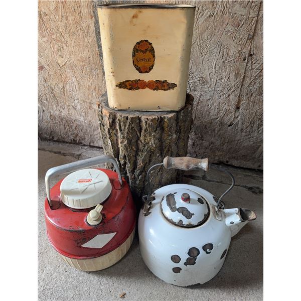 Metal Storage Canister with Floral Print, Red Plastic Jug, and White Metal Kettle