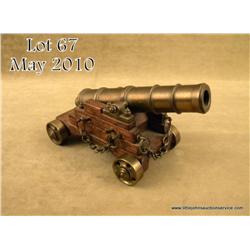 Small model of a brass deck cannon on wood  carriage with brass wheels in overall very good  conditi